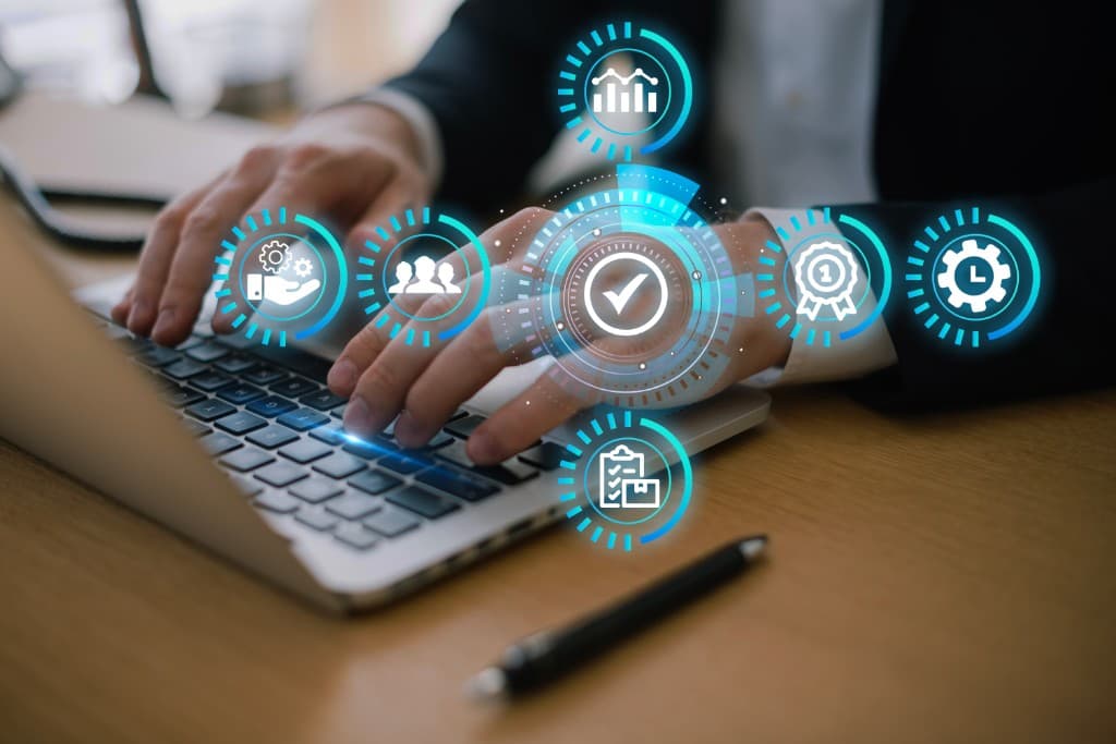 Quality and operations control icons over a laptop workspace