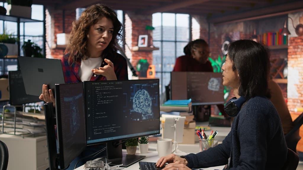 Team collaborating on AI agent workflows at a workstation